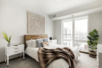 a bedroom with a large bed and a large window